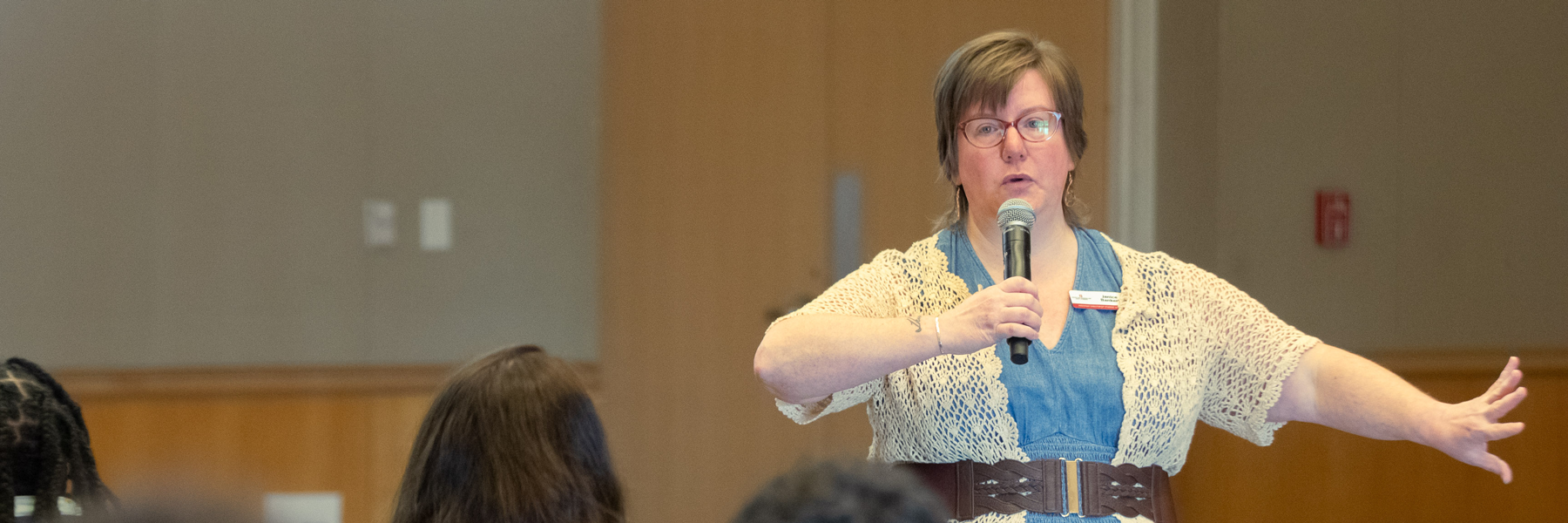 A woman is giving a presentation during the Disability Awareness Month luncheon.